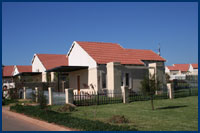 White Bage House With Red Roof